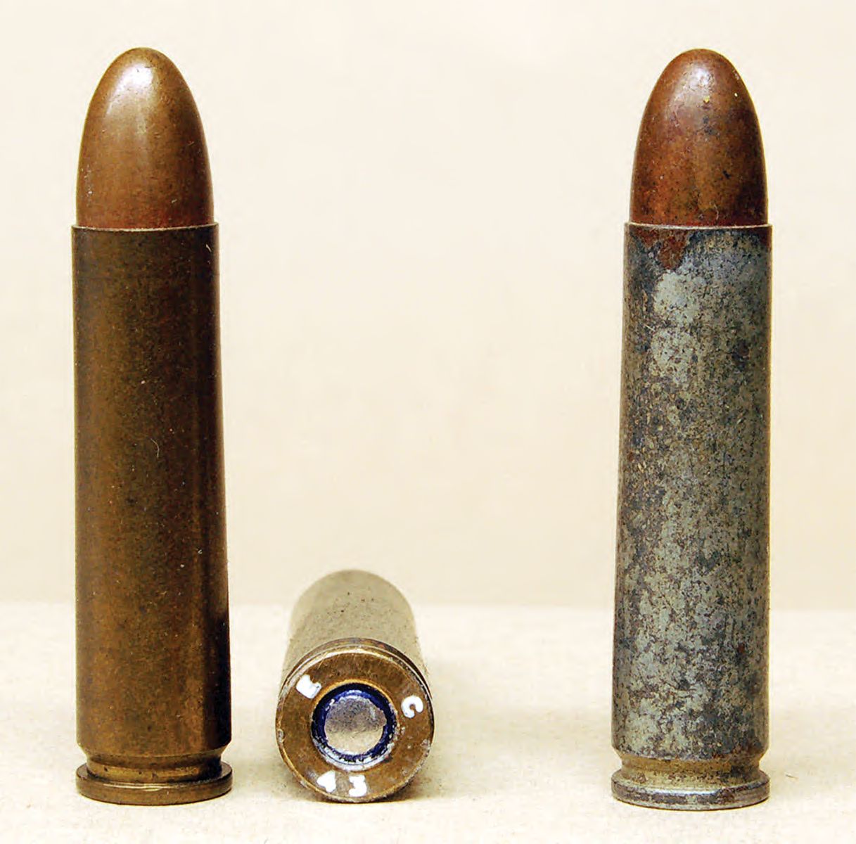 An Evansville brass-cased .30 Carbine headstamped E C 43 and a steel-cased round with the same headstamp. EC made about 500 million .30 Carbine rounds in both brass and steel.